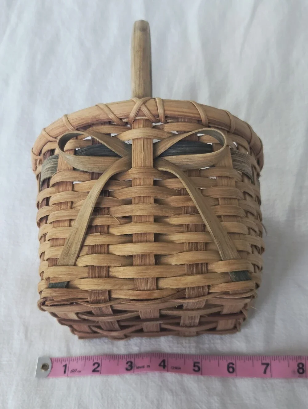 Vintage, Hand-Woven Basket Featuring A Unique Bow Detail And Green Accent